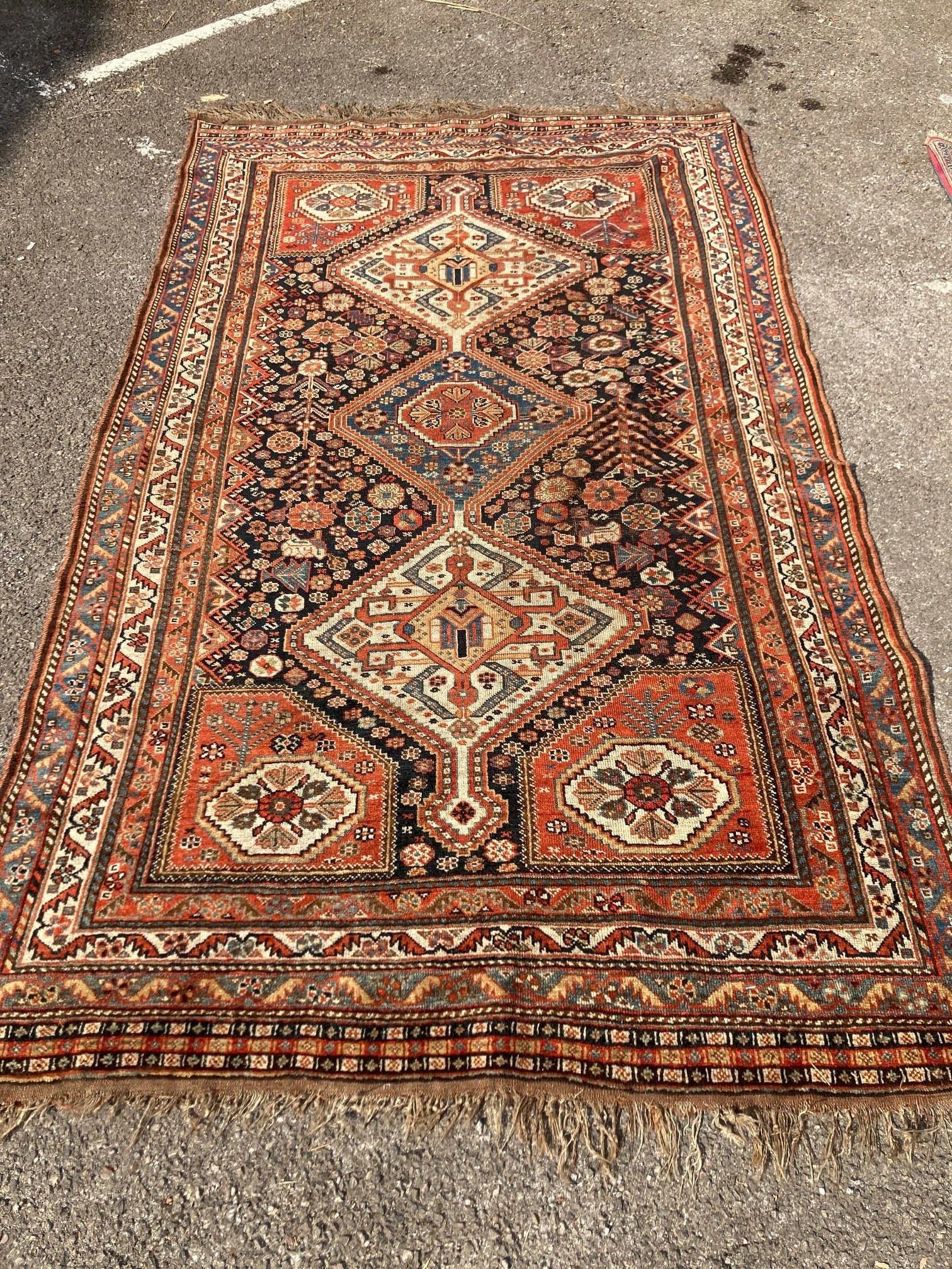 An early 20th century Persian blue ground rug, having three central medallions and floral decoration, 250 x 146cm